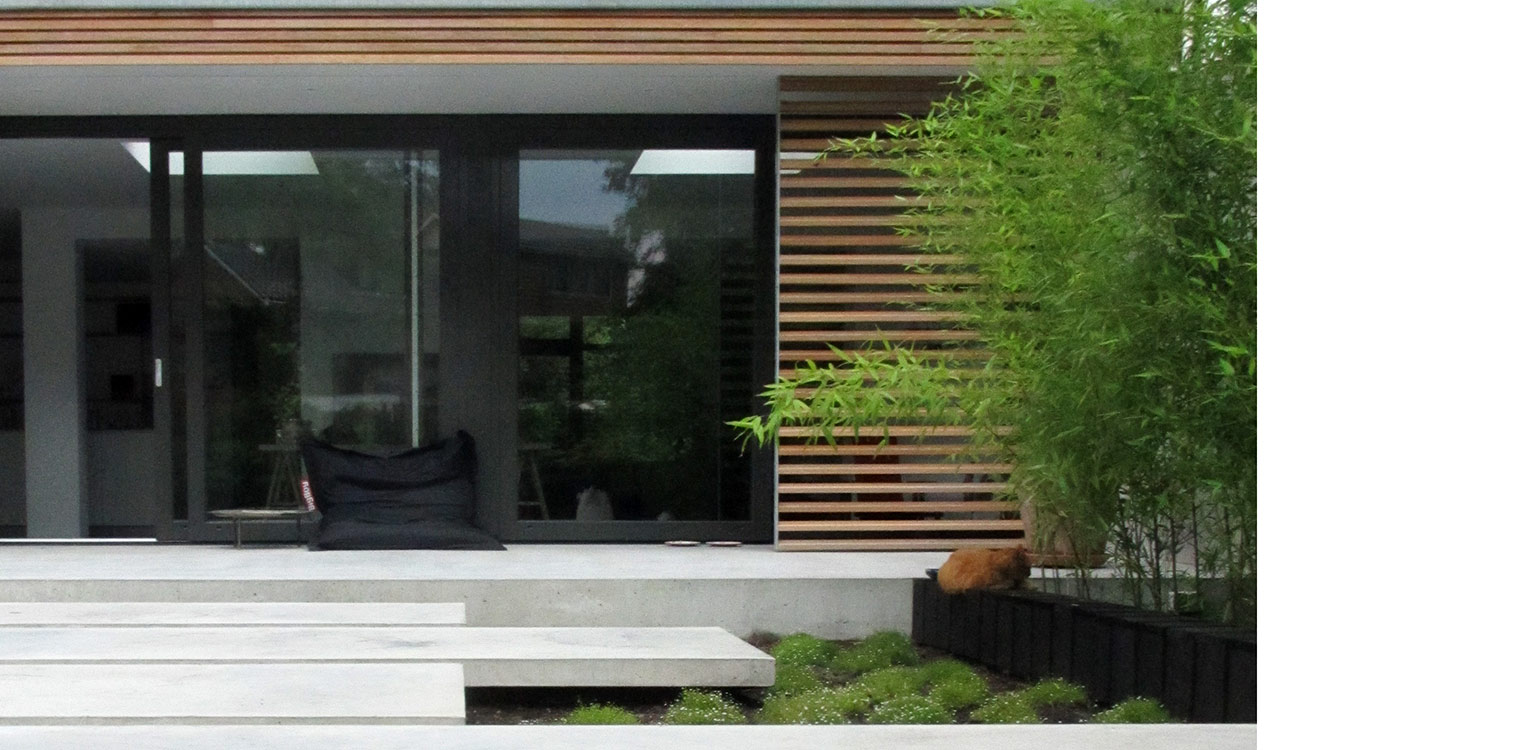 bamboe en betonterras patiotuin Diepenveen. Het in de woning toegepaste beton is consequent in de buitenruimte doorgetrokken - mede als podium voor kunst - Denkers in Tuinen